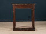 a small wooden table with a marble top on the floor