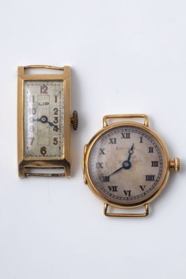 two watches sitting next to each other on a white surface