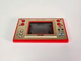 an image of a red and yellow game console sitting on top of a white table