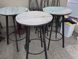 four stools and a table on the patio