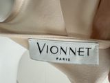 a picture of a woman ' s dress label on a mannequin dress