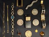 a lot of gold and silver jewelry on a black table