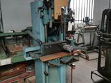 a machine that is sitting in a room with many pieces of wood