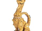 figurine de dragon jaune aux yeux et aux dents verts sur fond blanc