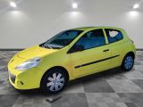 a yellow car is parked in a room with a checkered floor
