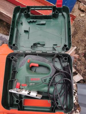 a green box with tools in it sitting on the ground