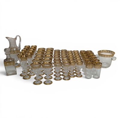 a group of gold and glass items sitting on top of a white surface