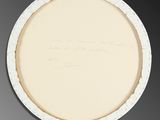 an oval white plate with writing on it sitting on a table