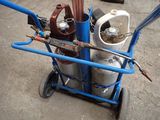 a blue cart with a bunch of gas bottles on it