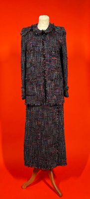 an image of a dress and coat on a mannequin stand