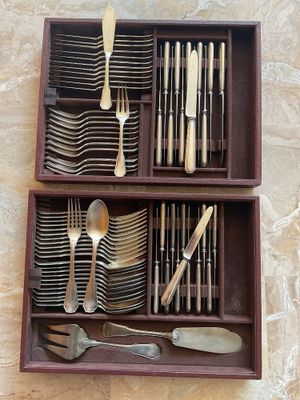 a wooden box with silverware in it on a table