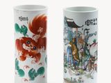 pair of chinese porcelain vases with characters on them on a white background