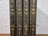 a set of three books sitting on top of a wooden table
