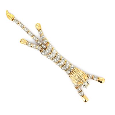 a close up of a gold and diamond broochle