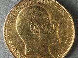 a close up of a gold coin with a man ' s face on it
