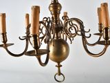 a chandelier that has five candles on it