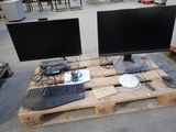 two monitors and a keyboard on a pallet in a warehouse