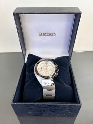 the watch is in a box on the table ready to be worn