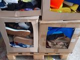 two cardboard boxes with different types of clothing in them