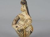 an image of a figurine of a woman holding a basket