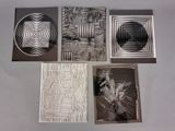 four different types of metal artwork are displayed on a table
