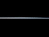 a metal object that is on a black surface