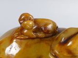a figurine of an elephant with a baby on its back