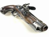 an old gun with a wooden handle on a white surface