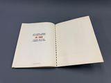 an open book on a table with a black background