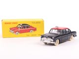 a small toy car next to a box on a white surface