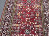 an image of a large red rug with a pattern on it