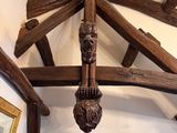 a wooden sculpture hanging from the ceiling of a room