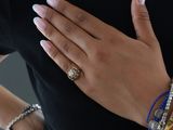 a woman that is wearing some bracelets and a ring