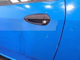 a close up of a blue car door handle