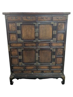 a wooden chest of drawers with many drawers on top of it