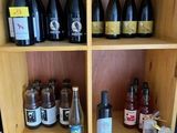 many bottles of wine sitting on a shelf in a room