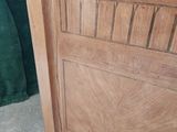 a wooden cabinet with a marble top on the floor