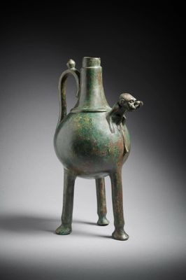 an image of a green vase with a monkey on the handle