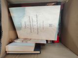 a box full of books that are sitting on the floor