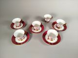 six tasses et soucoupes sont posées sur une table