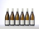 six bottles of wine are lined up on a table