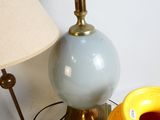 two yellow vases and a lamp on a table