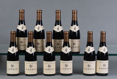 six bottles of wine are lined up in a row on a table