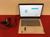 a laptop computer sitting on a red table with a charger