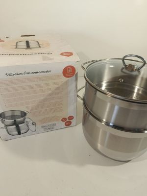 a stainless steel pot and a box on the table