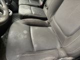 the interior of a car with the front seats covered in dirt