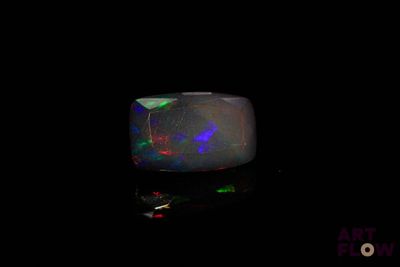 a black oplite ring with multi colored lights on it