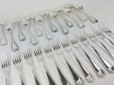 a lot of forks and spoons on the table
