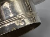 a silver cup that is sitting on a table