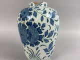 a blue and white vase sitting on a table